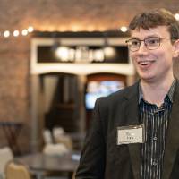 Kyle Perry smiling and looking off-camera